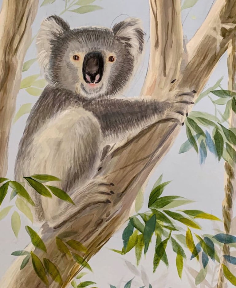 Hand-painted koala resting in a gum tree — Australian nursery mural detail in calm neutral tones.