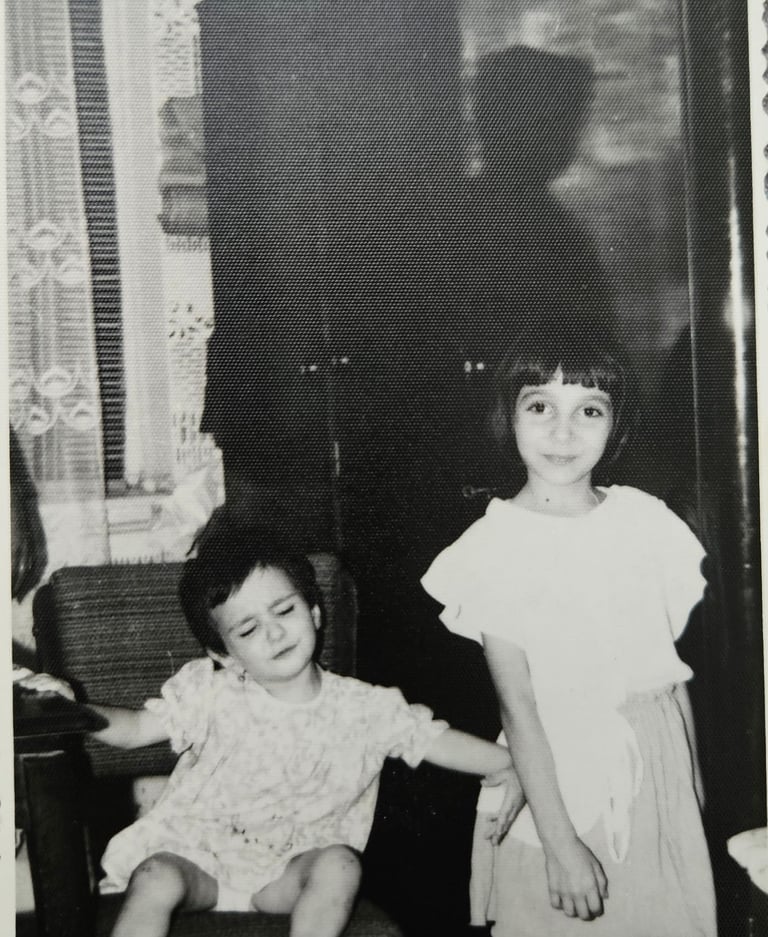 a little girl pushing another girl from the frame