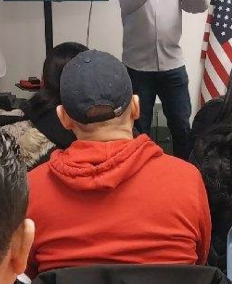 a man in a red jacket is giving a presentation