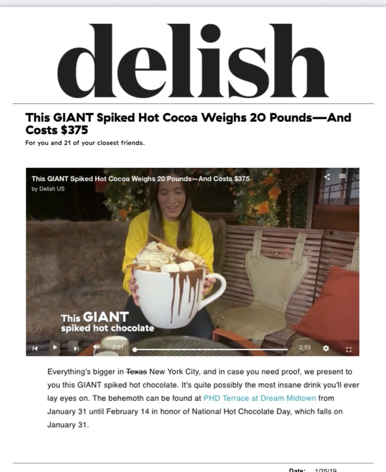 a lady holding a 20 lb boozy hot chocolate