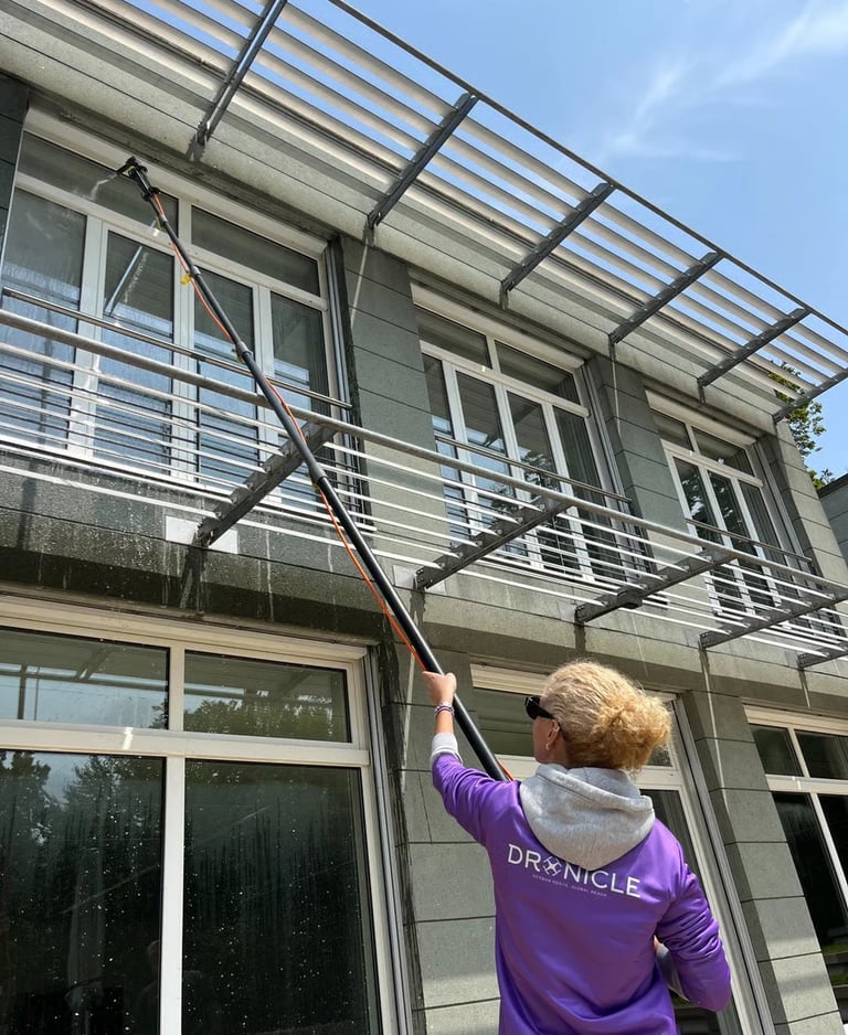 Dronicle spraying filtered water on windows