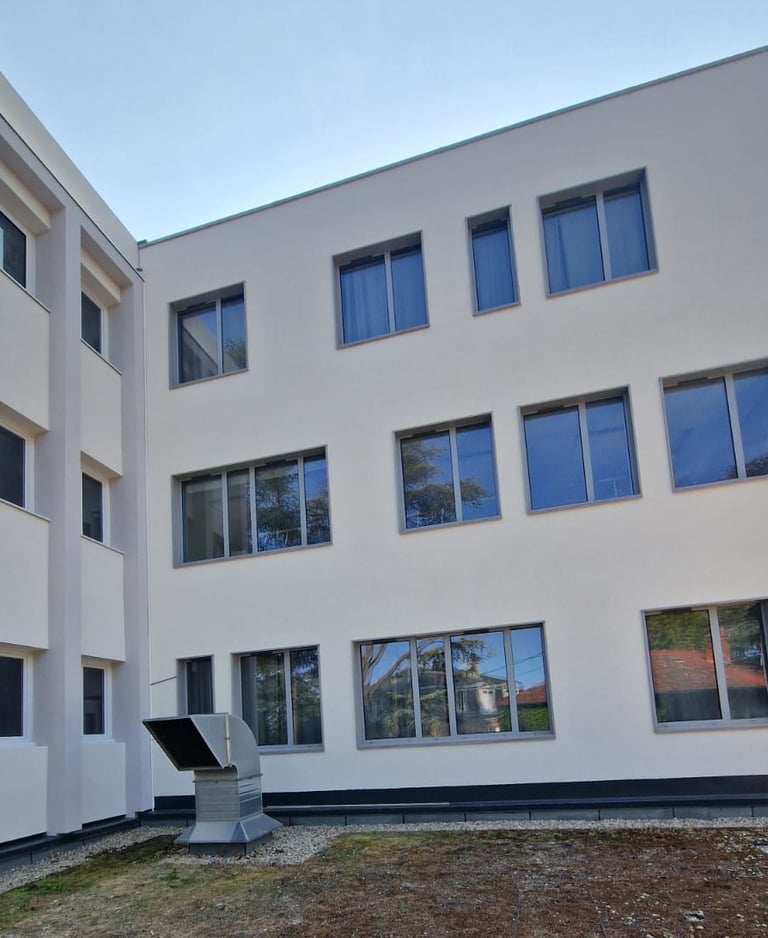 a building with a large window and a sculpture of a sculpture