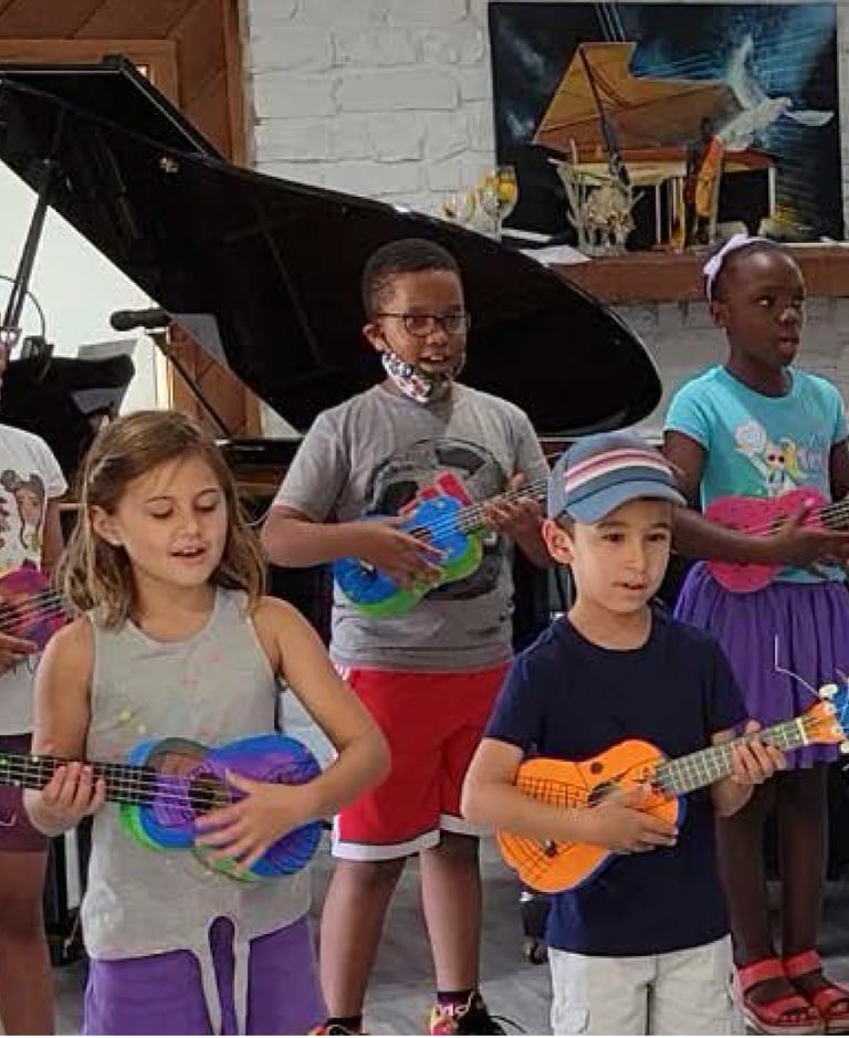 a group of children playing ukulele and singing