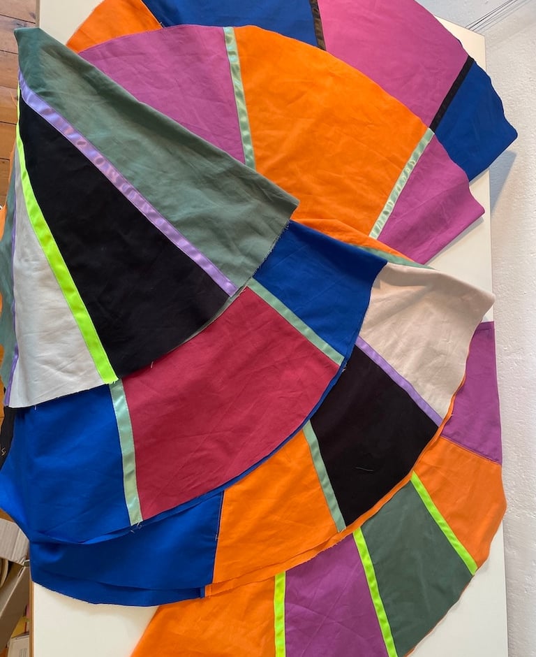 Handmade colorful patchwork fabric panels featuring vibrant geometric shapes for textile art projects.