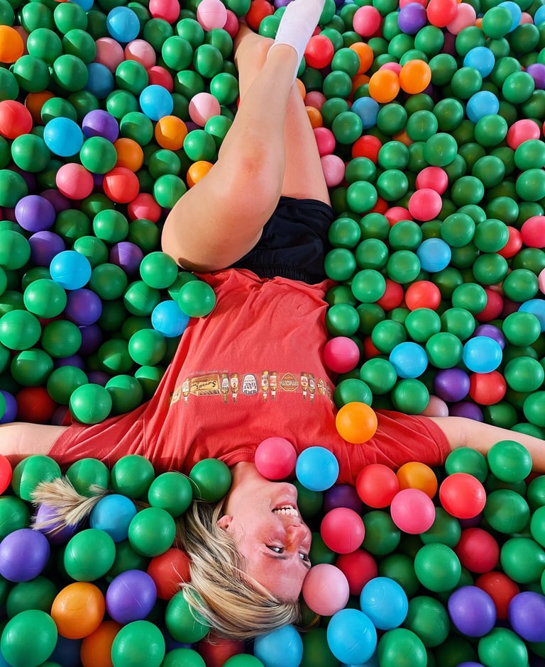 Ashley-Shae Benton filming fun short-form video content in colorful ball pit setting