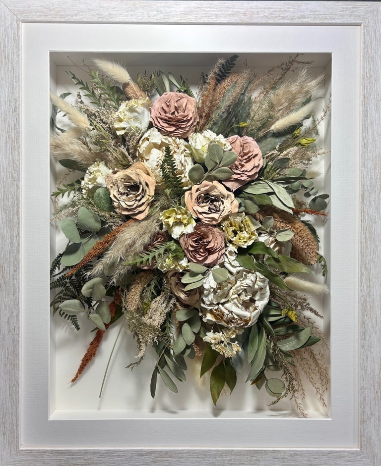 trailing view preserved wedding bouquet with lots of dried stems in a frame