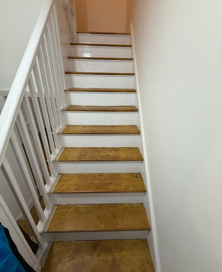 Indoor wooden staircase with light oak steps and white banister spindles in Brighton. 