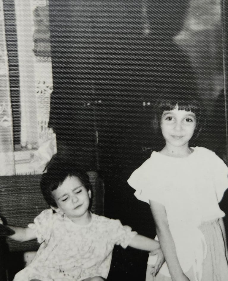 a little girl pushing another girl from the frame