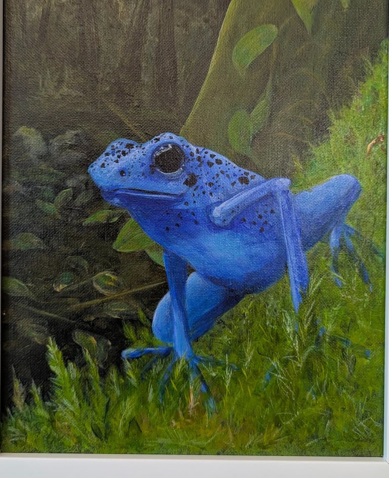 A realistically acrylic painted blue dart frog perched on green mosses.