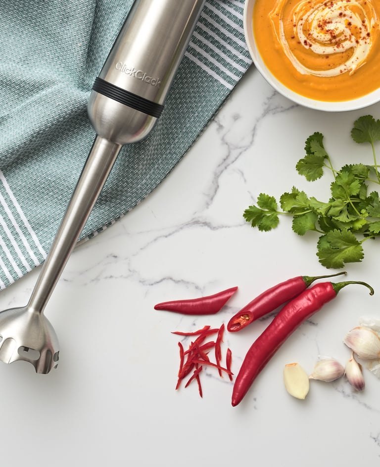 Product photography - a blender with a bowl of soup and ingredients