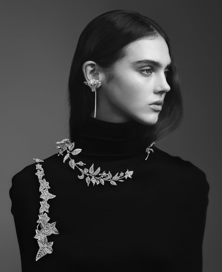 Model with nature-inspired boucheron diamond jewelry on neckline and ear.