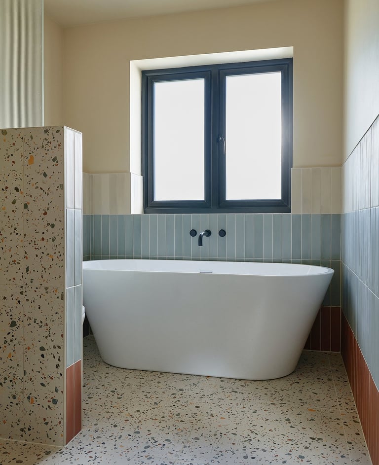 large-format terrazzo tiles strong contrasting tile strip in a wet room 