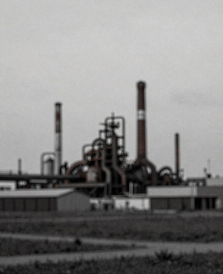 Fine art photography of an industrial landscape, grainy film texture, minimalist composition with muted tones of #8C9CA6.