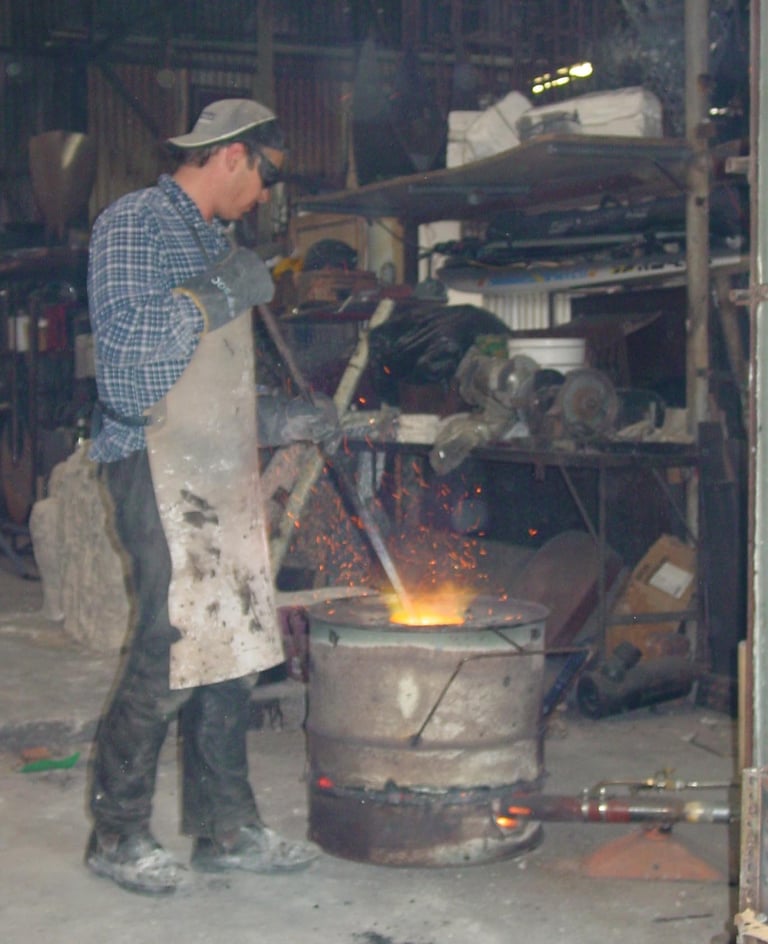Matt stirring the bronze in the crucible