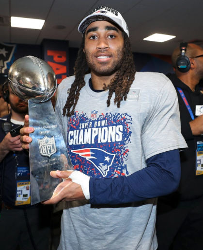 Stephon Gilmore holding the Lombardi Trophy following the Patriots victory of the Rams in Super Bowl LIII