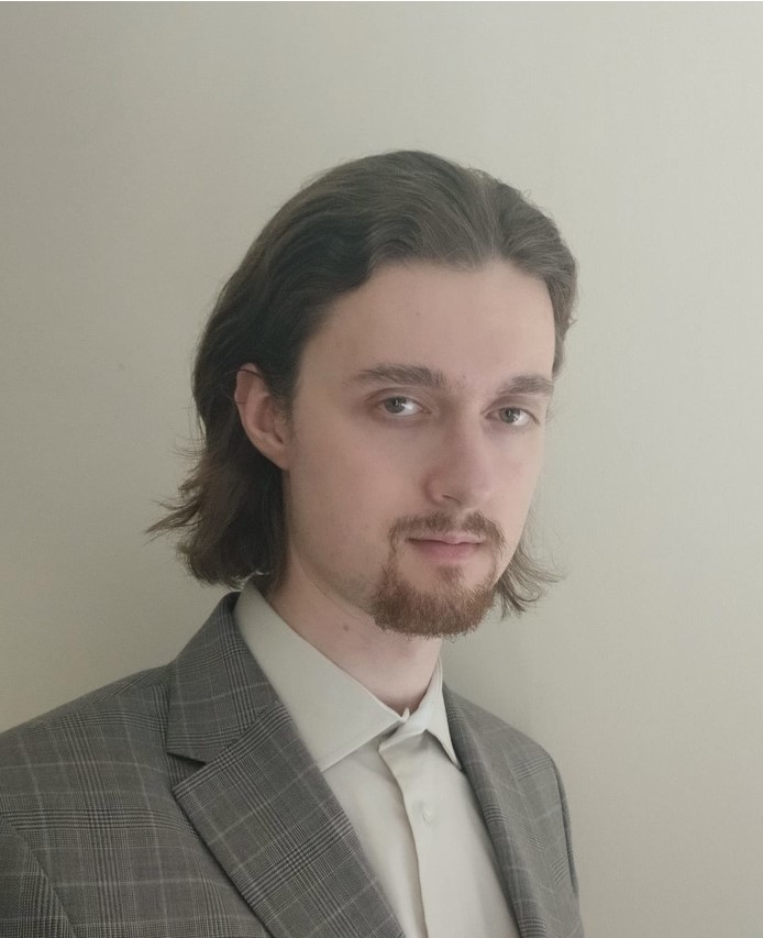 a man with a beard and a suit jacket