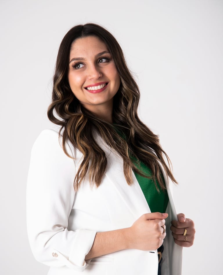 a woman in a white coat and green tie
