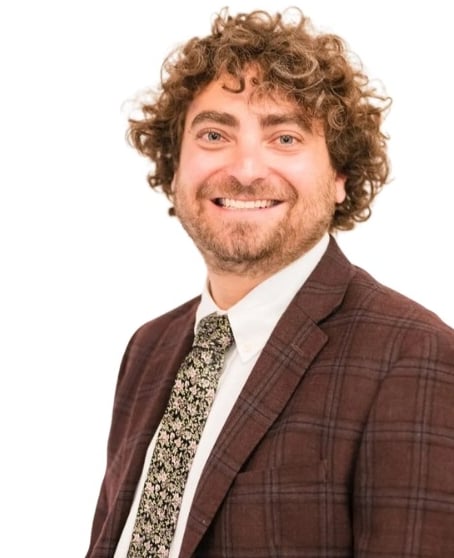 Ari Malman, Denver Attorney; a man in a suit and tie smiling