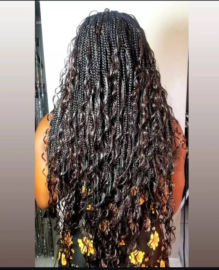 a woman with curly goddess braids