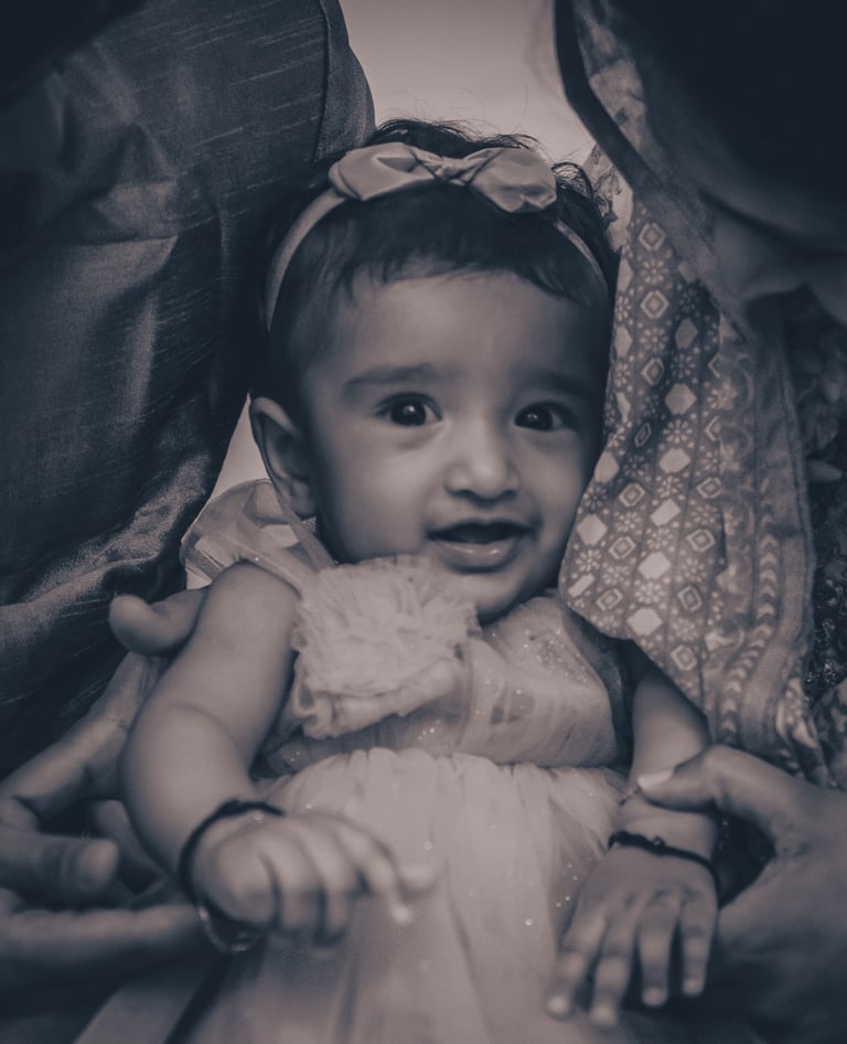 a baby girl in a white dress and a man in a suit