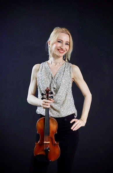 Houston violin teacher and performing violinist with her violin