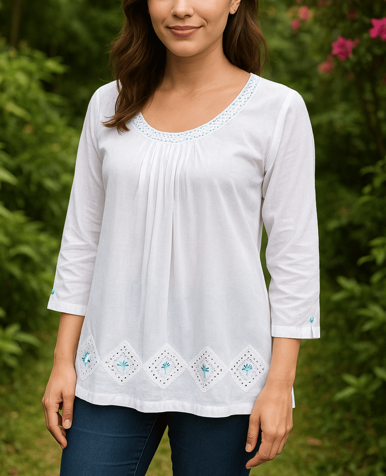 a woman in a white shirt and jeans standing in front of a bush