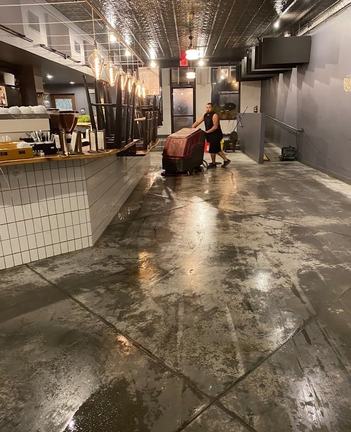 CONCRETE STAINING PROFESSIONAL WORKING IN A BUSINESS