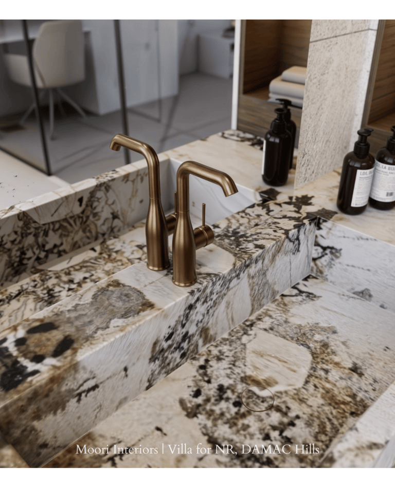 Elegant bathroom sink area showcasing a brass faucet and a distinctive marble countertop.