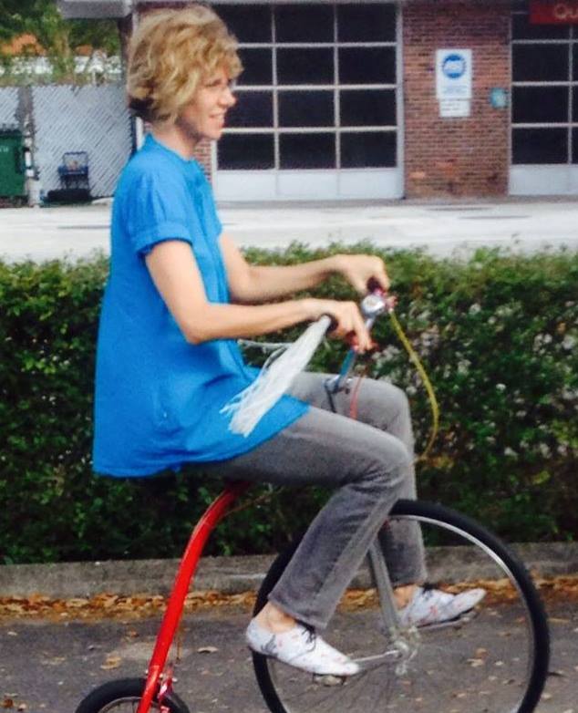 Image of author Dawn Davies riding a large front-wheel tricycle