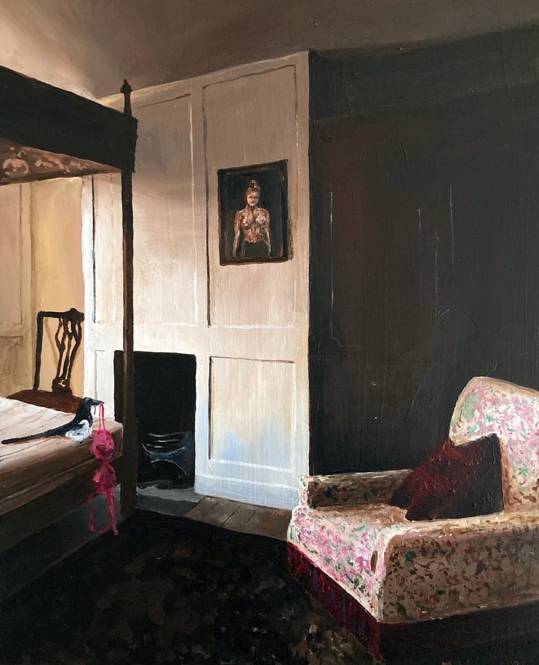 a bedroom with a bed and a chair. magpie sits on th ebed holdig a bra