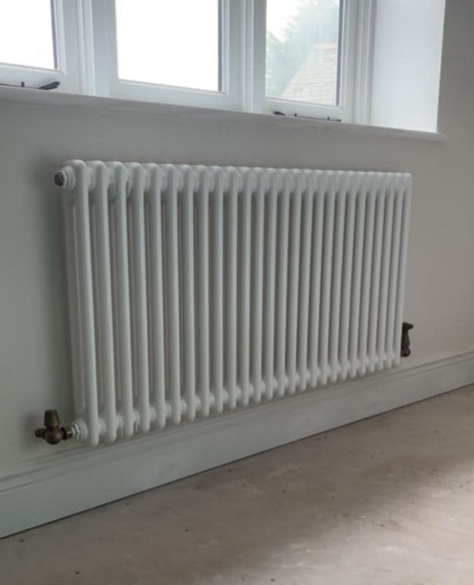 Compact radiator replacement in Evesham kitchen with clean pipework finish