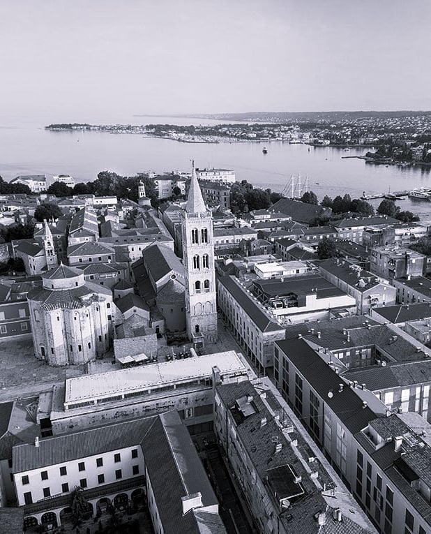 A bird view photo of Zadar peninsula, with the Church of St. Donatus, The Cathedral and Bell Tower