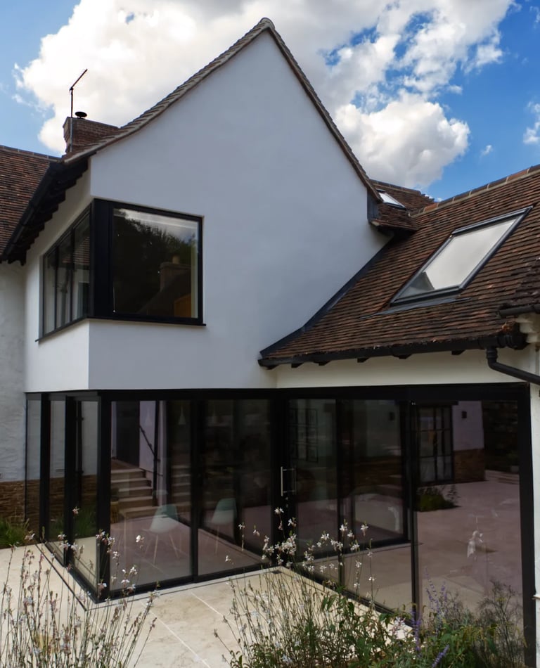 Large sliding doors and glazing creating a modern aesthetic to a home extension.
