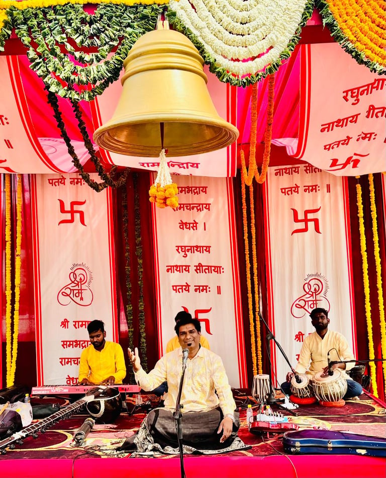 Indian musicians performing devotional bhajan music at a Hindu temple with a brass bell and traditional instruments.