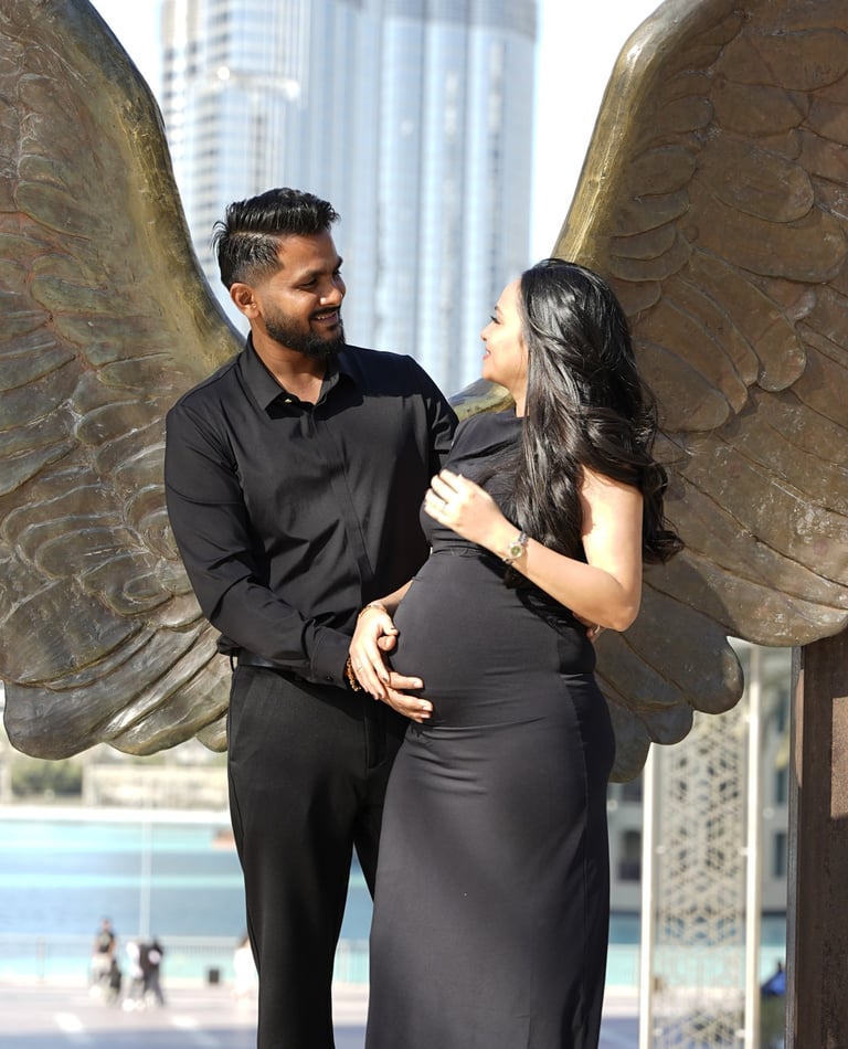 Black-and-white maternity portrait – Expecting mother holding belly at Wings of Mexico Dubai.