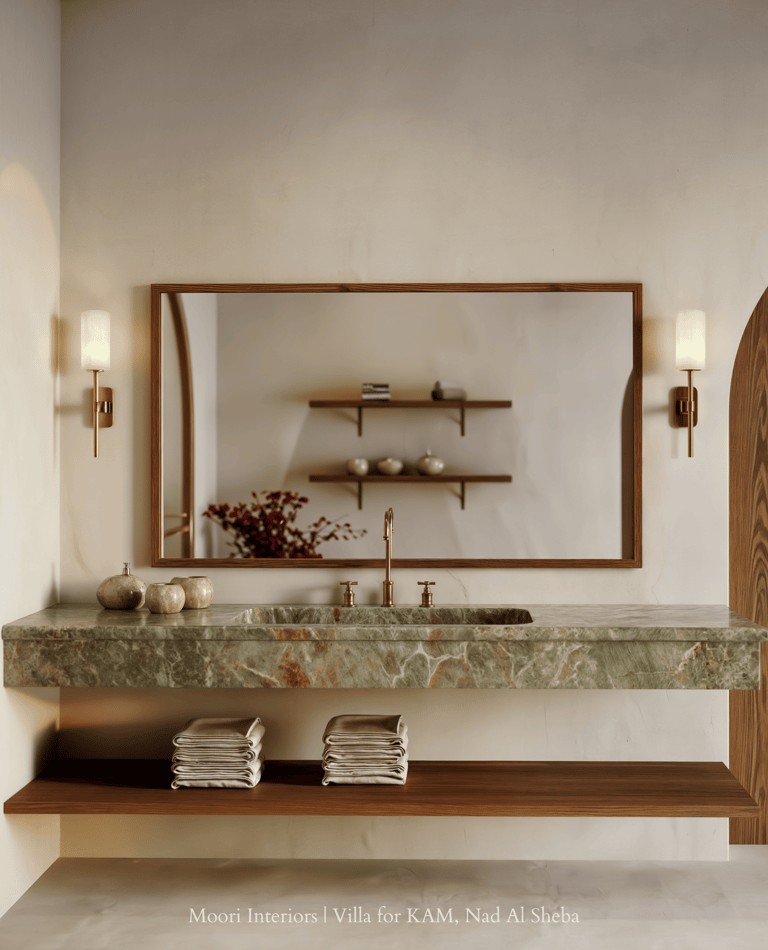 Green onyx vanity with wood accents and ambient wall sconces in luxury bathroom.