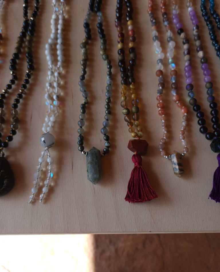 Hand-knotted gemstone mala necklace with 108 beads, created by Tina Medina for spiritual meditation and energy healing