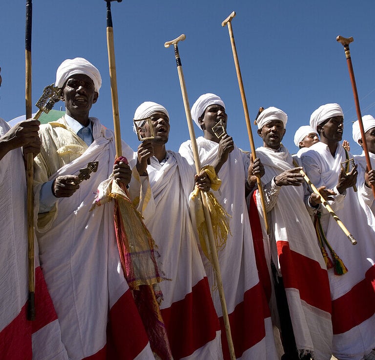 a group of men in white and red robes and white robes