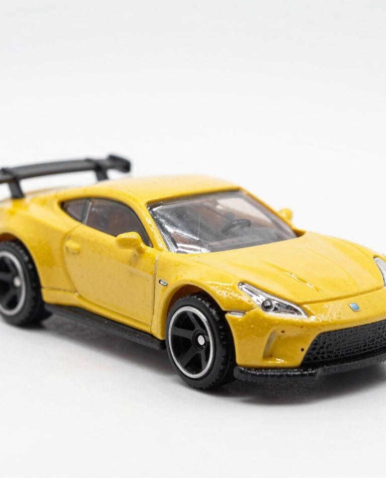 Close-up of a rugged RC crawler toy climbing over rocky terrain.