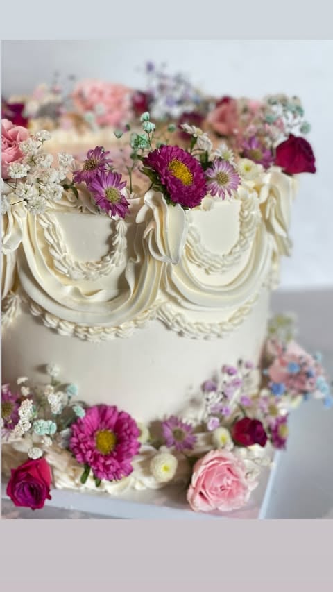 a cake with flowers on top of a white table
