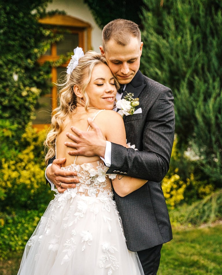 a bride and groom embracing each other in a garden