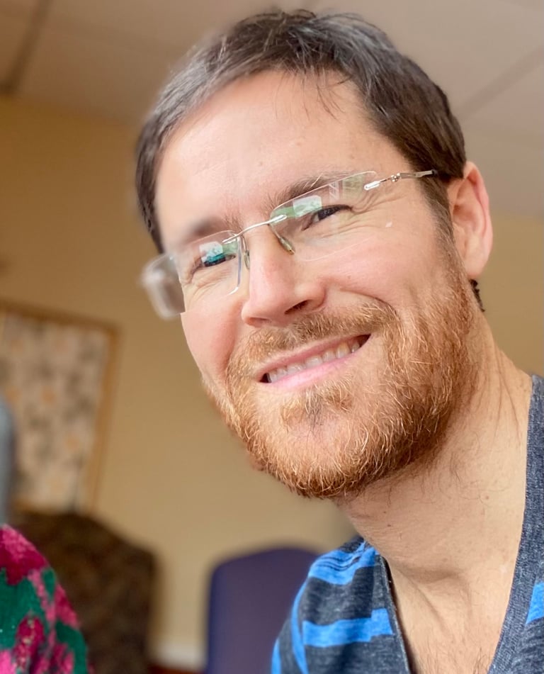 a man with glasses and a striped shirt