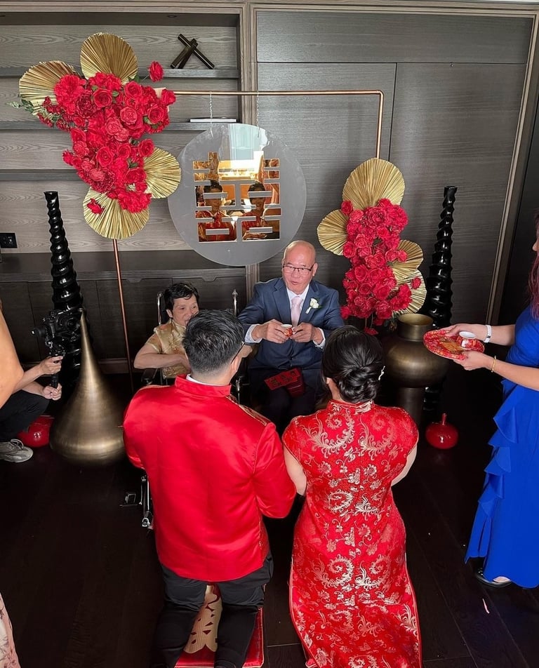 A family celebrating with each other with the Chinese tea ceremony backdrop