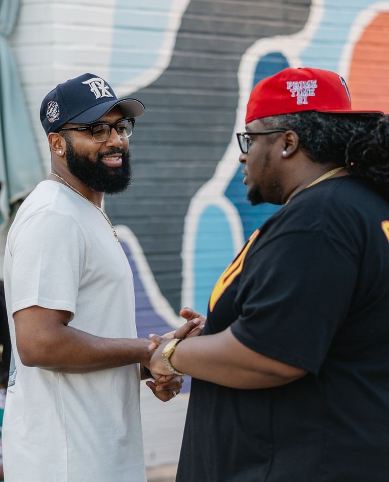 a man in a white shirt and a man in a red hat