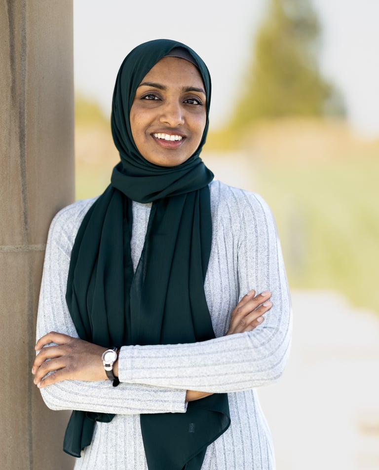a woman in a white dress and black scarf