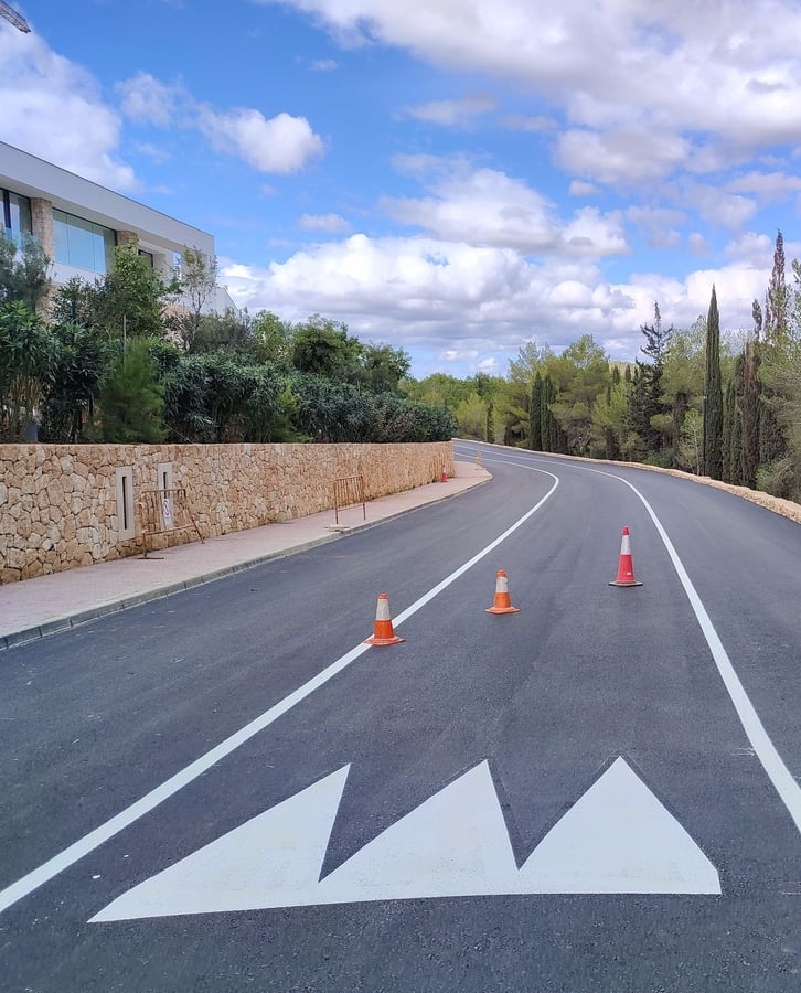 Señalización vial de advertencia con dientes de dragón en calzada