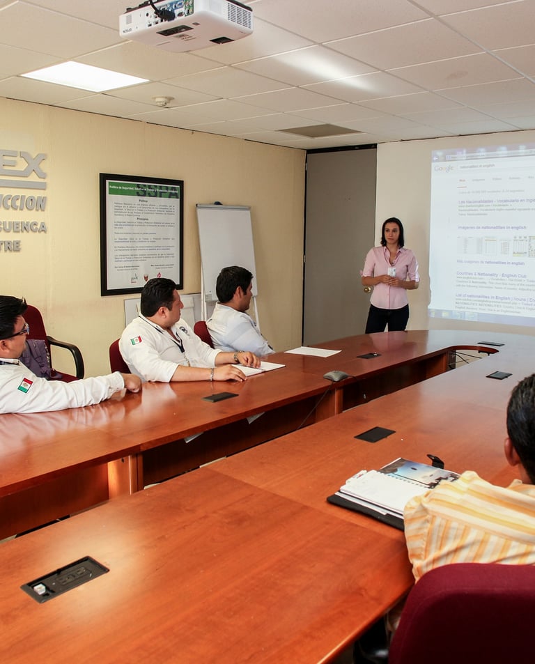 a group of people sitting at a table with a presentation
