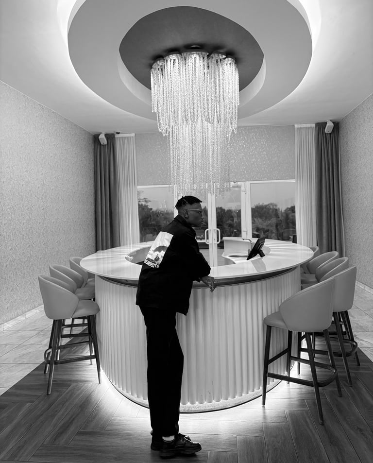 reed standing in front of a bar with a chandelier