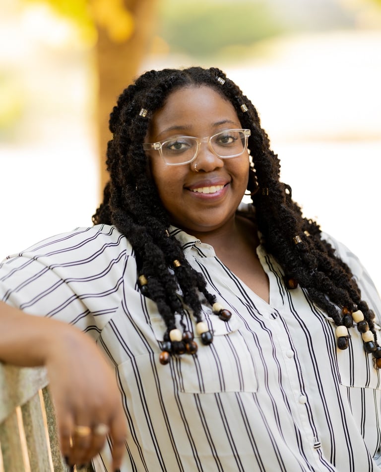 a woman with glasses and a striped shirt