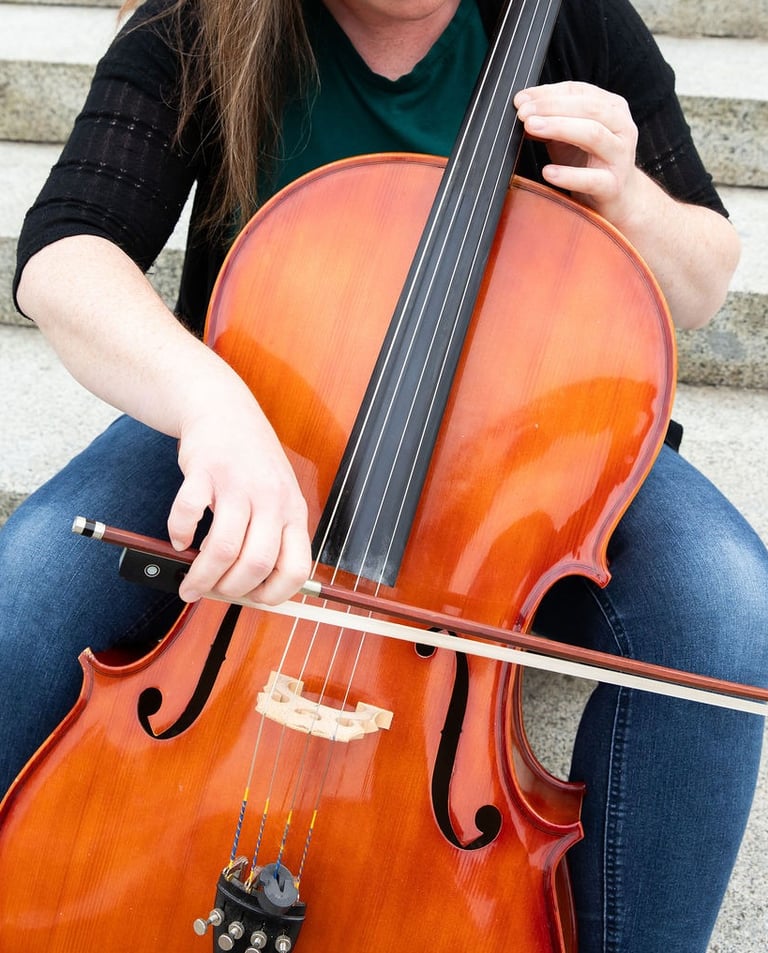 Cello instructor showing bow technique on cello